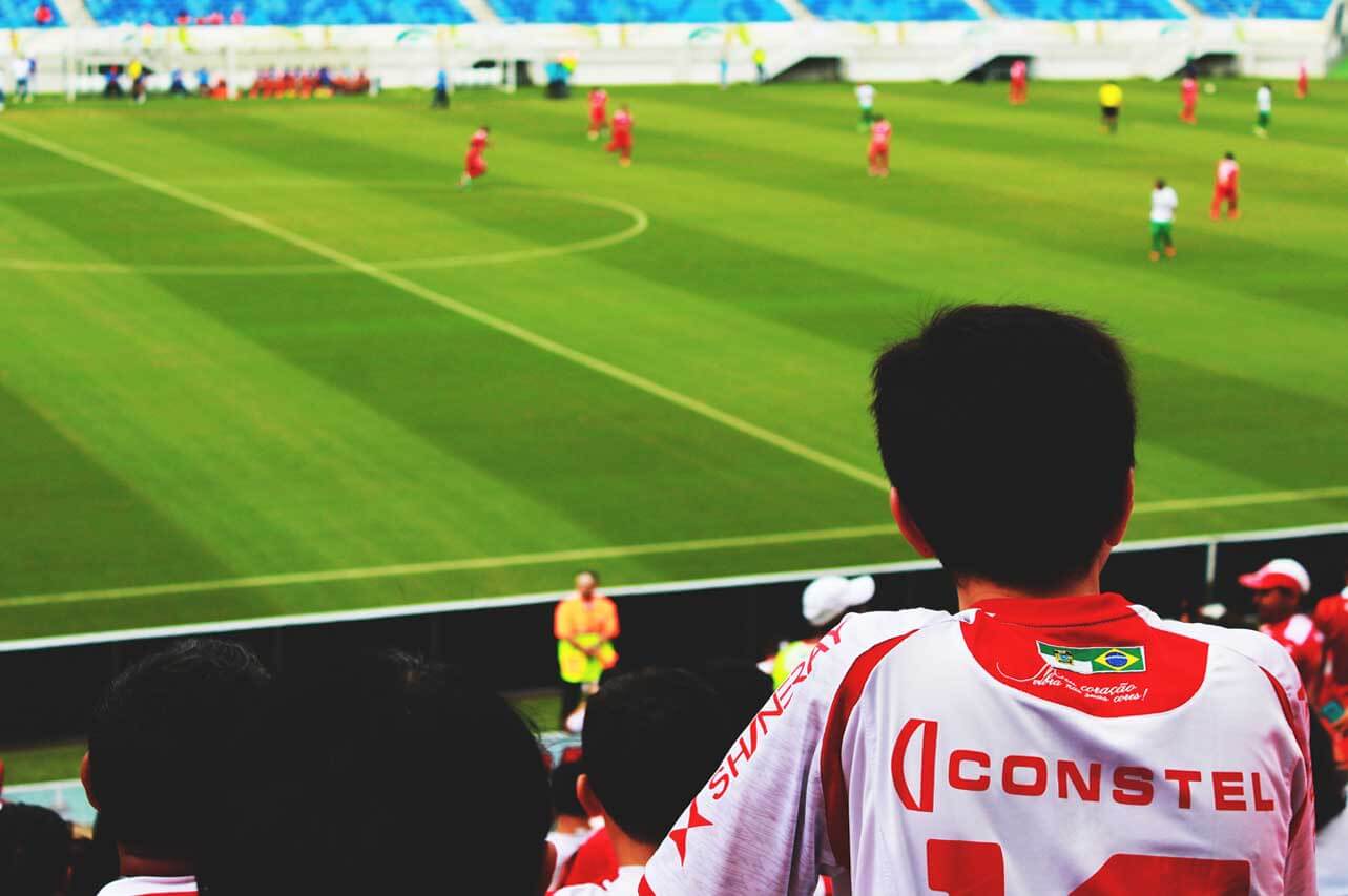 White and Red Jersey Shirt Looking at Sport Game